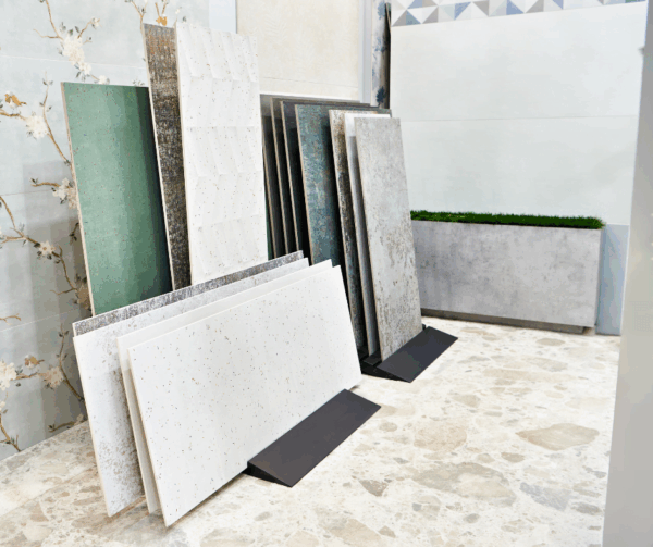 A variety of modern surface tiles in different colors and textures displayed in a showroom.